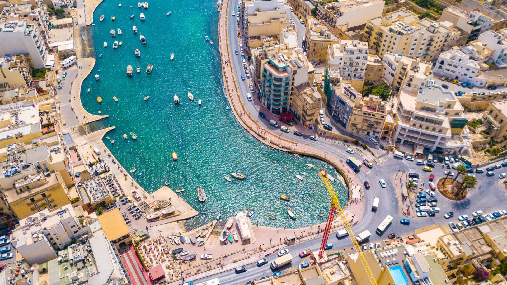 An aerial shot of the buildings and houses by the bay